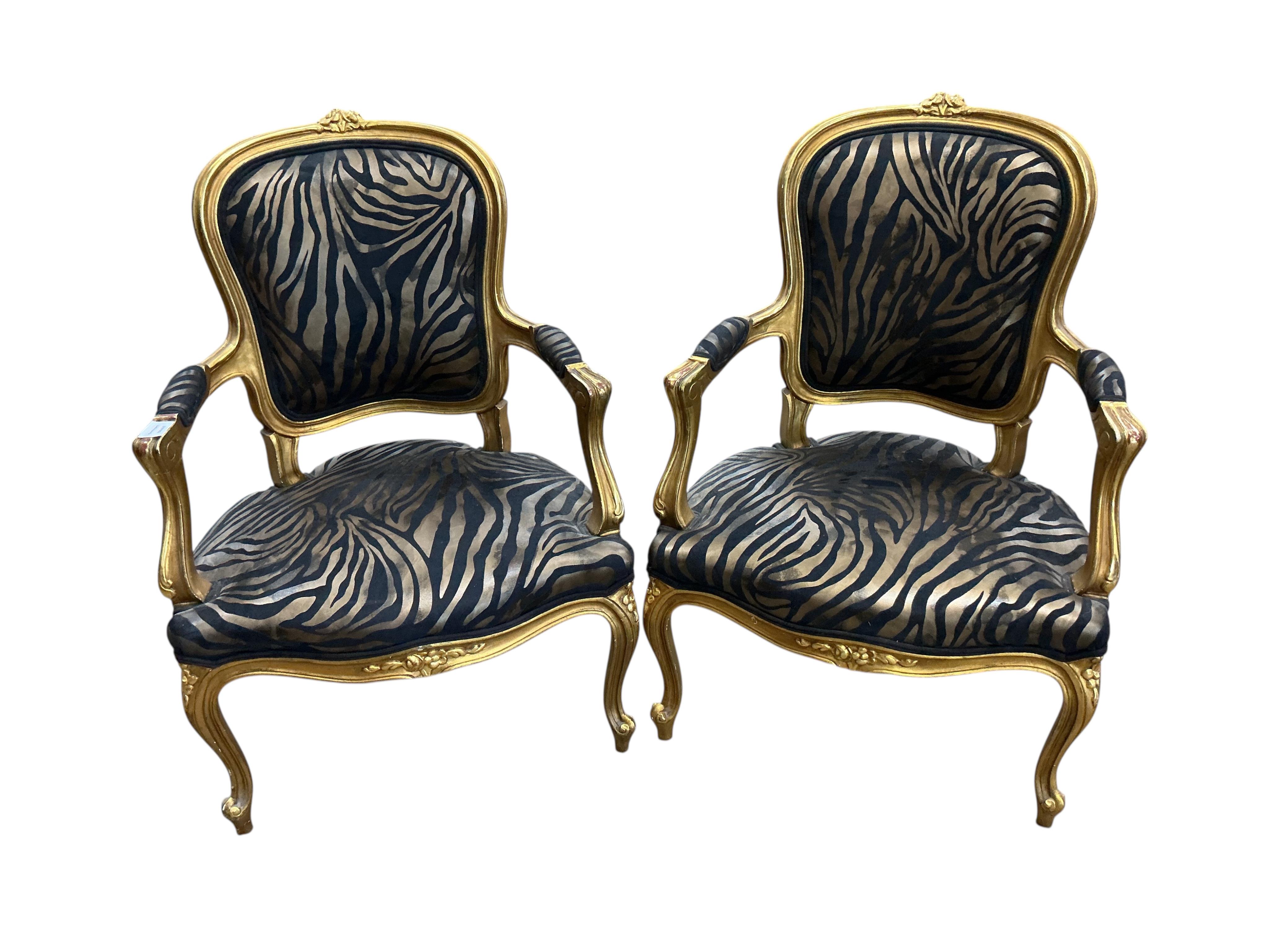 A pair of Louis XVI style fauteuil with faux zebra print upholstery, width 59cm, depth 46cm, height 92cm